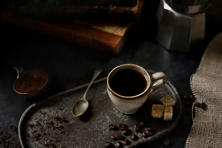 A moody setup featuring black coffee in a ceramic mug with rustic elements.